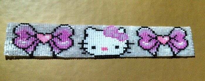 Pink, white, and black handmade beaded bracelet with bow details